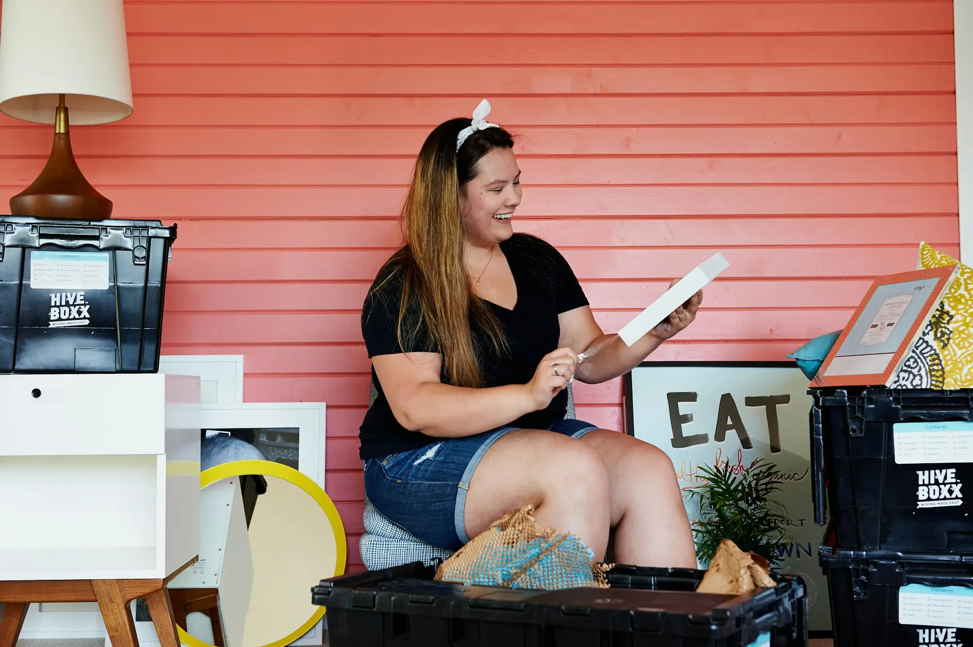 Business owner reading a letter while sitting outside her shop